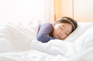 cute asian girl sleep in white blanket