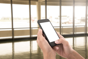 hand holding smart phone screen isolated with blurred abstract hallway background.