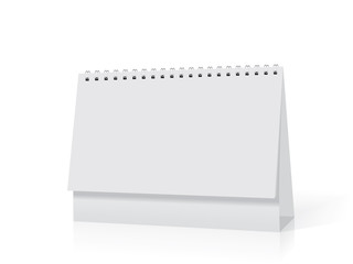 A paper white calendar stands on the table.