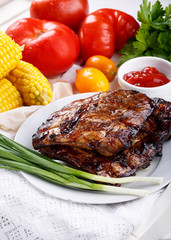 Grilled pork ribs. Meat bbq ribs served with sauce and fresh vegetables.