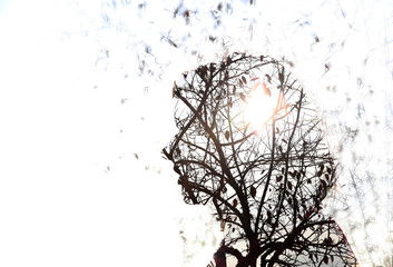 Portrait of a young woman with the effect of double exposure.