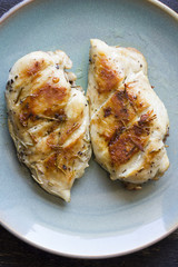 Chicken fillet laying around on a white background