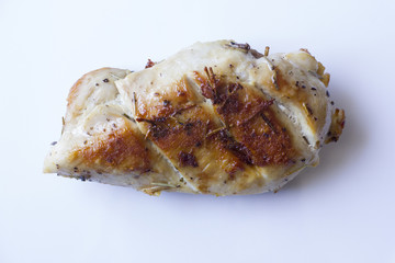 Chicken fillet laying around on a white background