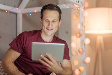 Relaxed male person watching video