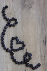 Blueberries on wooden background; Healthy heart symbol