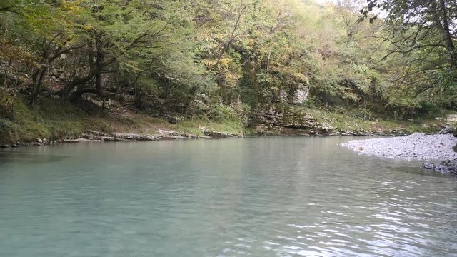 Crystal water with white stones in martvili canyon