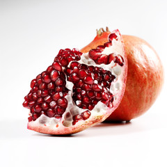 Two pomegrantes on a white  background.