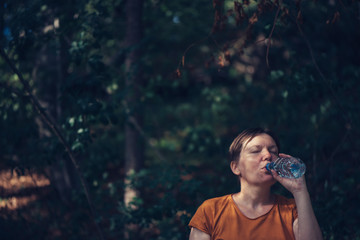 Woman drinking water outdoors
