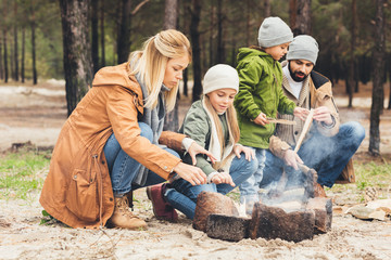 family making campfire