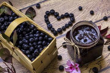 Organic homemade blueberry jam; Basket full with fresh blueberries
