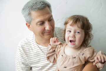 Funny time. Father and his child are playing at home. Family holiday and togetherness. Family portrait.