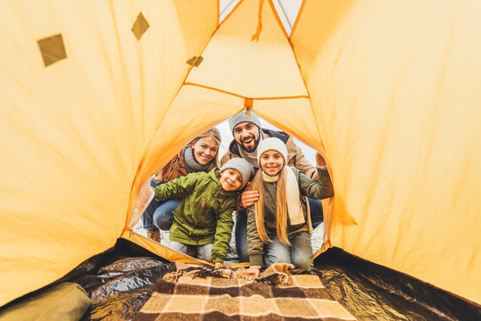 family looking at camping tent