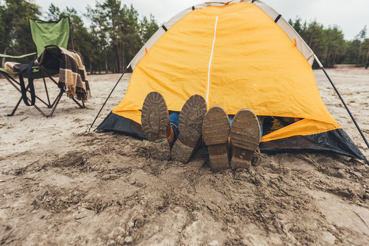 couple laying in camping tent - Powered by Adobe