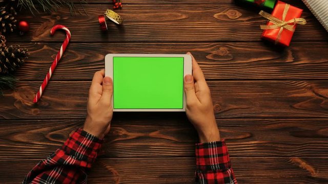 Top view of man working on the tablet, New Year atmosphere, Green sreen, chroma key