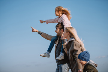 parents and kids pointing somewhere