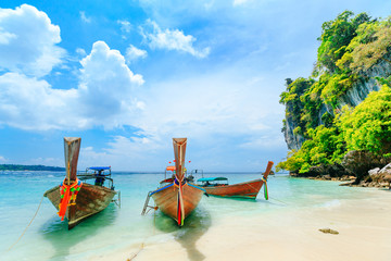 Longtale boat on the white beach at Phuket, Thailand. Phuket is a popular destination famous for...