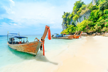 Fototapeta na wymiar Longtale boat on the white beach at Phuket, Thailand. Phuket is a popular destination famous for its beaches.