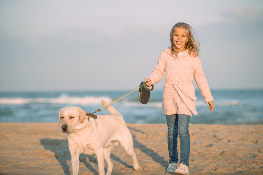 Kid Walking With Dog At Seaside