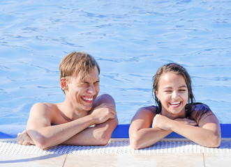 Happy young couple in swimming pool