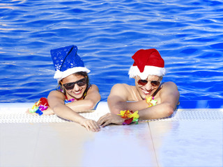 Romantic couple hugging in swimming pool, enjoying in tropical Christmas vacations