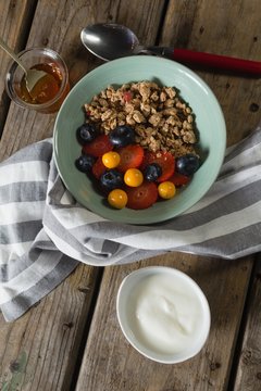 Fruit cereal in bowl on a wooden table
