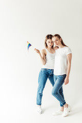 Lesbian couple with small rainbow flag