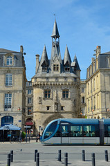 Famous ancient city gate and a modern tram in Bordeaux