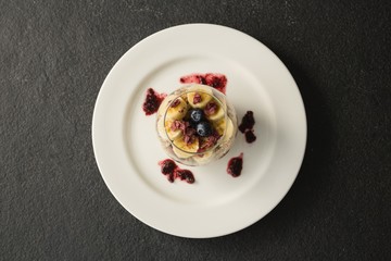 Fruit cereal in jar on concrete background