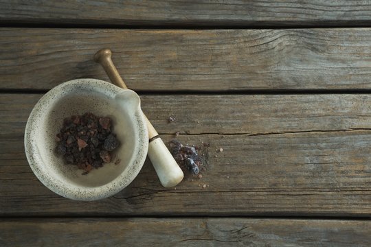 Black salt in mortar on wooden table