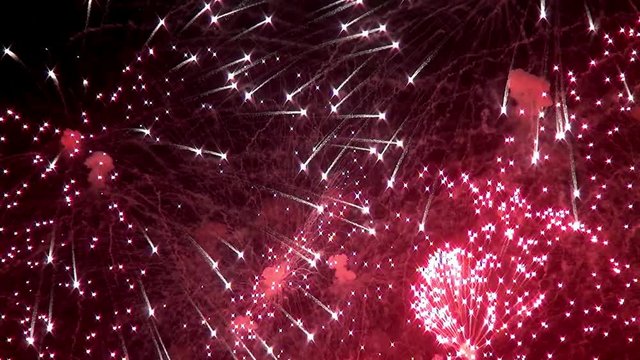 Bright red green yellow explosions of firework display on black background. Amazingly beautiful. Salute for new year, Christmas and other holidays. Macro video closeup footage 50p.