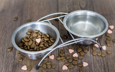 dry dog food and water in bowls  and vitamins for healthy  dog treats 