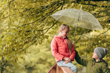 kids with umbrella in park