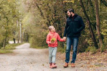 Fototapeta premium father and daughter walking in park