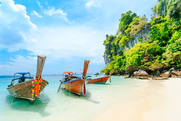 Fototapeta na wymiar Longtale boat on the white beach at Phuket, Thailand. Phuket is a popular destination famous for its beaches.