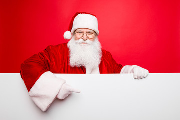 Advertisement, discounts, presents gifts selling december, winter tradition wish, celebration of christmastime  concept. Santa is standing behind the white blank banner and points at side, empty