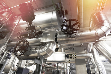 Equipment, cables and piping as found inside of a modern industrial power plant