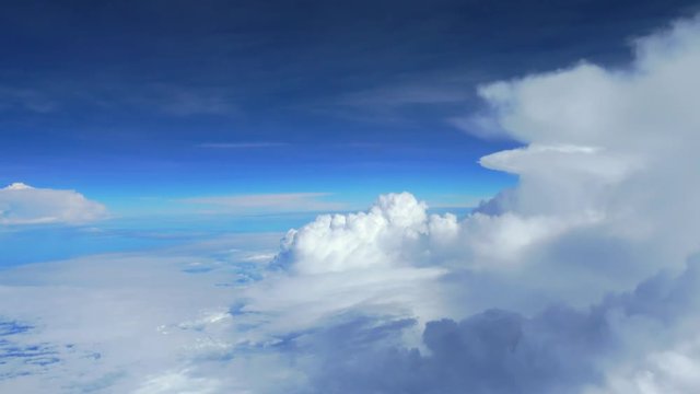 Above the clouds, flying in the air, Clouds against blue sky view through an airplane window for a background.video 4k
