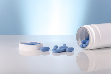 medical viagra blue tablets over white and blue background. - obrazy, fototapety, plakaty