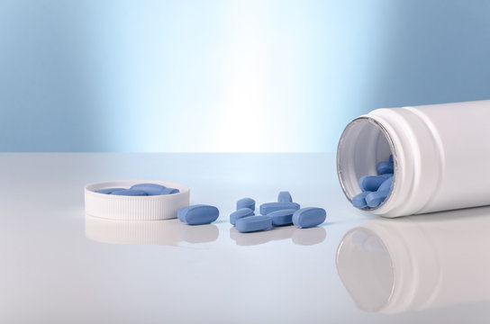 medical viagra blue tablets over white and blue background.