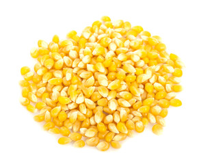 Pile of yellow corn kernels isolated over the white background