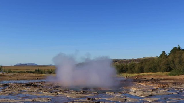 Famous Geyser eruption in a sunny day, Iceland 

