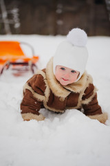 cute girl with sled in snow