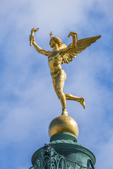 Gilded statue Genie de la Liberte at July Column on Bastille Square. Place de la Bastille - square in Paris, where Bastille prison stood until "Storming of Bastille" during French Revolution. France.