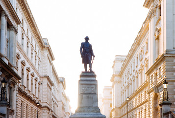 The sun rises behind a statue of Robert Clive at the Churchill War Rooms.