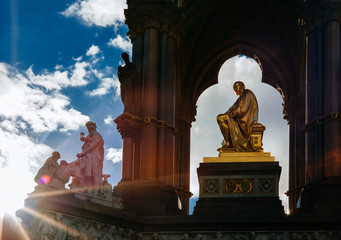 Setting sun flares out of the Albert Memorial in Hyde Park.