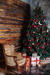 Christmas and New Year decorated interior room with presents and New year tree.Classic red and gold decor