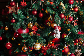 Christmas tree decoration on the branches.Red and gold toys and balls close-up.New Year background