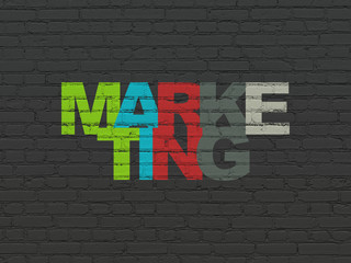 Marketing concept: Painted multicolor text Marketing on Black Brick wall background