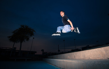 inline skater man jumps in the street