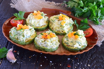 Grilled zucchini with cheese and garlic topping